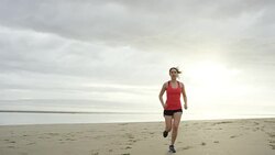 Beautiful woman running on the beach Stock Footage