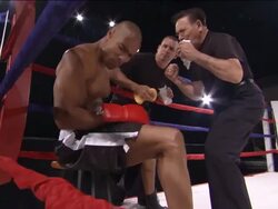 LA MS Trainer giving pep talk to boxer in ring while another man pours water into his mouth and wipes his face / Jacksonville, Florida, USA Stock Footage