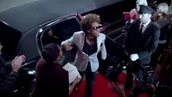 Chauffeur opens limousine door for hip-hop artist on red carpet at awards show Stock Footage