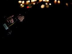 Picking guitar by the city road in night Stock Footage