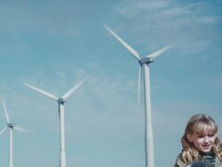MS TD Girl playing with pinwheel in front of wind turbines / Zillah, Washington, USA   Stock Footage