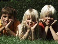 Kids lying on gras (Shot with Red) Stock Footage