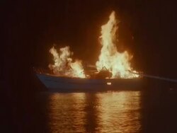 WS View of burning sailboat / Unspecified Stock Footage