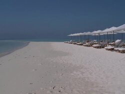 Beach chairs and parasols at the Four Seasons Resort, Landaa Giraavaru, Baa Atoll, The Maldives Stock Footage