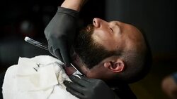 Close-up of beautiful attractive adult man with beard in a barber shop Stock Footage