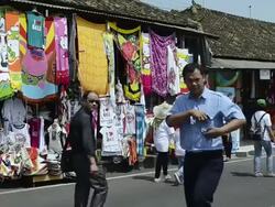 MS Tourists passing infront of Souvenir shops / Tanah Lot, Bali, Indonesia Stock Footage