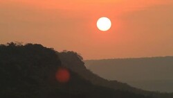 Sunrise through flowing cloud waves, mountain Stock Footage