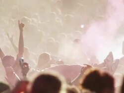 crowd of people at a Hindu festival throwing colored powder into the air and dancing Stock Footage