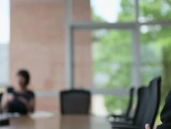 MS PAN R/F mature businessman in discussion with coworkers at conference table/Seattle, Washington, USA Stock Footage