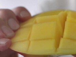 Cubed mango splayed by hands Stock Footage