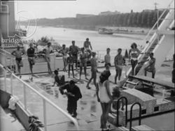 Photographers take photos of women in bikinis and in a garden, made in France, 1956 Stock Footage