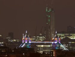 MS T/L PAN Shot of Tower Bridge illuminated at night with draw bridge raising and lowering / London, United Kingdom Stock Footage