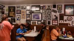Tupelo Mississippi Elvis Presley birth place and restaurant he ate at called Johnnie's Drive In Bar-B-Q interior with customers eating Stock Footage