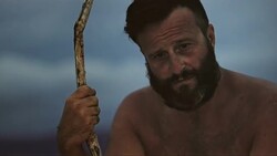 SLO MO Pondering man on an island by the fire Stock Footage