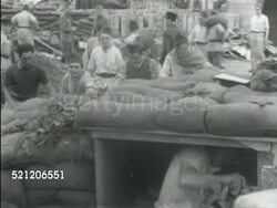 MOT 1939: FRANCE: FORTIFYING PARIS: *HA LS La Tour Eiffel (Eiffel Tower) in distant fog, bush branch FG. WS French soldiers stacking sandbags, pillar holding statue on Pont Alexandre III Bridge BG. MS French soldiers forming bunker w/ sandbags. Instructional Video