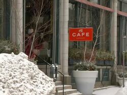 WS Two men hide from the snow by cafe entrance / Minneapolis, Minnesota, United States Stock Footage