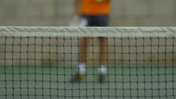 Male tennis player bouncing tennis ball with racket.  - Slow Motion Stock Footage