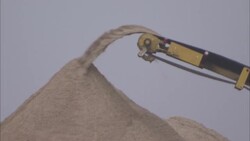 Dirt flows from construction equipment into a pile. Stock Footage