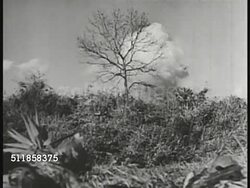 1937: JAPAN ATTACKS CHINA: Japanese soldiers firing artillery, group lobbing hand grenades, explosion behind hill. Imperial flag of Japan FG w/ bi-plane in sky BG. HAND-HELD: Japanese bomb exploding on Chinese town, people running, bomb exploding. Instructional Video