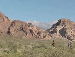 Couple mountain biking towards camera in rocky terrain Stock Footage
