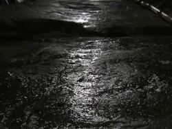 Runnels of water trickle through a sewer system tunnel below New York City. Stock Footage