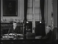 1944: BOSTON: WS Boston State house ('Towne House'). INT Governor Leverett A. Saltonstall (1892-1979) in office talking w/ Commissioner of Education Julius E. Warren. Bulletin board: 'Governor's Committee for Racial and Religious Understanding' Instructional Video