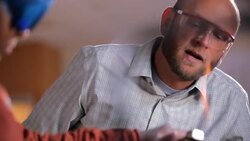Teacher supervises a student using Bunsen burner Stock Footage