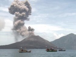 Boats on ocean near erupting Anak Krakatau volcano, Krakatoa, Indonesia, November 2010 Stock Footage
