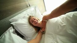 Young woman takes selfie in hotel room bed Stock Footage