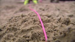 A fuse line arches across a pile of dirt. Stock Footage