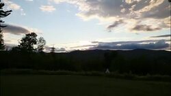 Cloud timelapse of a darkening sky with a teepee in the foregroud, 4K Stock Footage