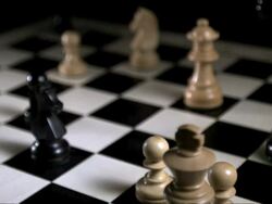 High speed white chess queen falling, some figures standing around, tracking shot Stock Footage