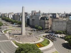TL, MS, HA Traffic passes the obelisk / Obelisco de Buenos Aires / Buenos Aires, Argentina Stock Footage