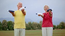 SLO MO DS Senior man and woman exercising in the park Stock Footage