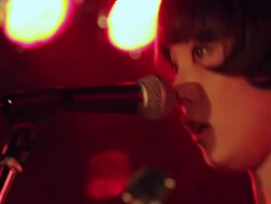 Female Bass guitarist singing and playing on stage. Stock Footage