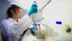 Two young sciences working in a lab Stock Footage