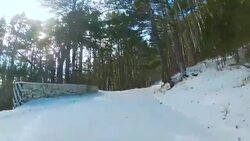 Winding road through forest in winter, Go Pro Stock Footage