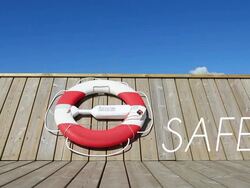 Life belt hanging on wooden pier or boat at midday Stock Footage