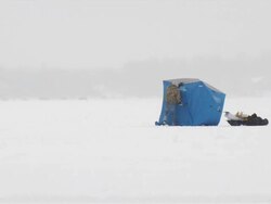 WS Man building ice fishing house on frozen lake during winter / Minneapolis, Minnesota, USA Stock Footage