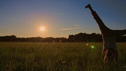 SLO MO Girl Doing Cartwheel On Meadow Stock Footage