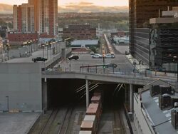 T/L of train approaching in urban setting Stock Footage