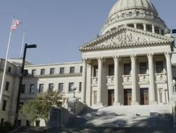 MS Shot of Mississippi Capitol building with American flag flying / Jackson, Mississippi, United States Stock Footage