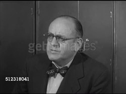 1952: COUNTY CLERK: ELKHORN: REENACTMENT: VS Claude Eames at county clerk office talking w/ county clerk Leo D. Dunlap about property tax, lowering taxes. Wisconsin, WI Instructional Video