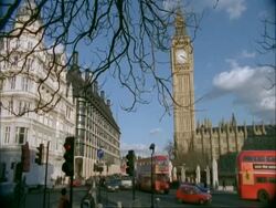 London Traffic - MS red buses and black cabs pass Big Ben in background Stock Footage