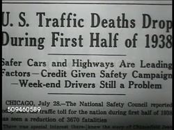 1938: SAFER DRIVING: Newspaper article header 'US Traffic Deaths Drop....of 1938' PATROLLING: NIGHT: WS (POV In front of) Highway Patrolman, motorcycle policeman riding in left lane passing traffic. Instructional Video