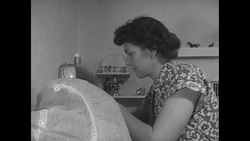 Iva Sprout sews on sewing machine at homestead in California News Clip
