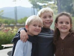  MS Children standing and smiling in front of patio fire pit / Stowe, Vermont Stock Footage