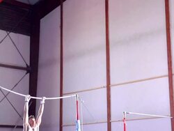 HD: Super Slo-Mo Gymnast Performing Routine on Horizontal Bar Stock Footage