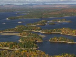 WS AERIAL ZI PAN View of wooded area with autumn color and lakes / Maine, United States Stock Footage