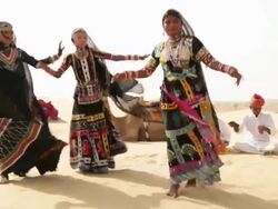 Three women dancing on desert, Sam Desert, Jaisalmer, Rajasthan, India Stock Footage